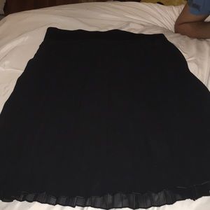 Black pleated knee length skirt